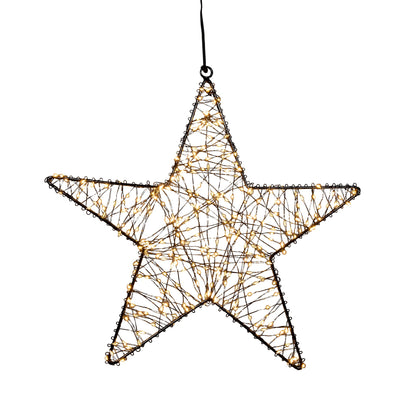 Julestjerne til vindu. Elegant julebelysning ute