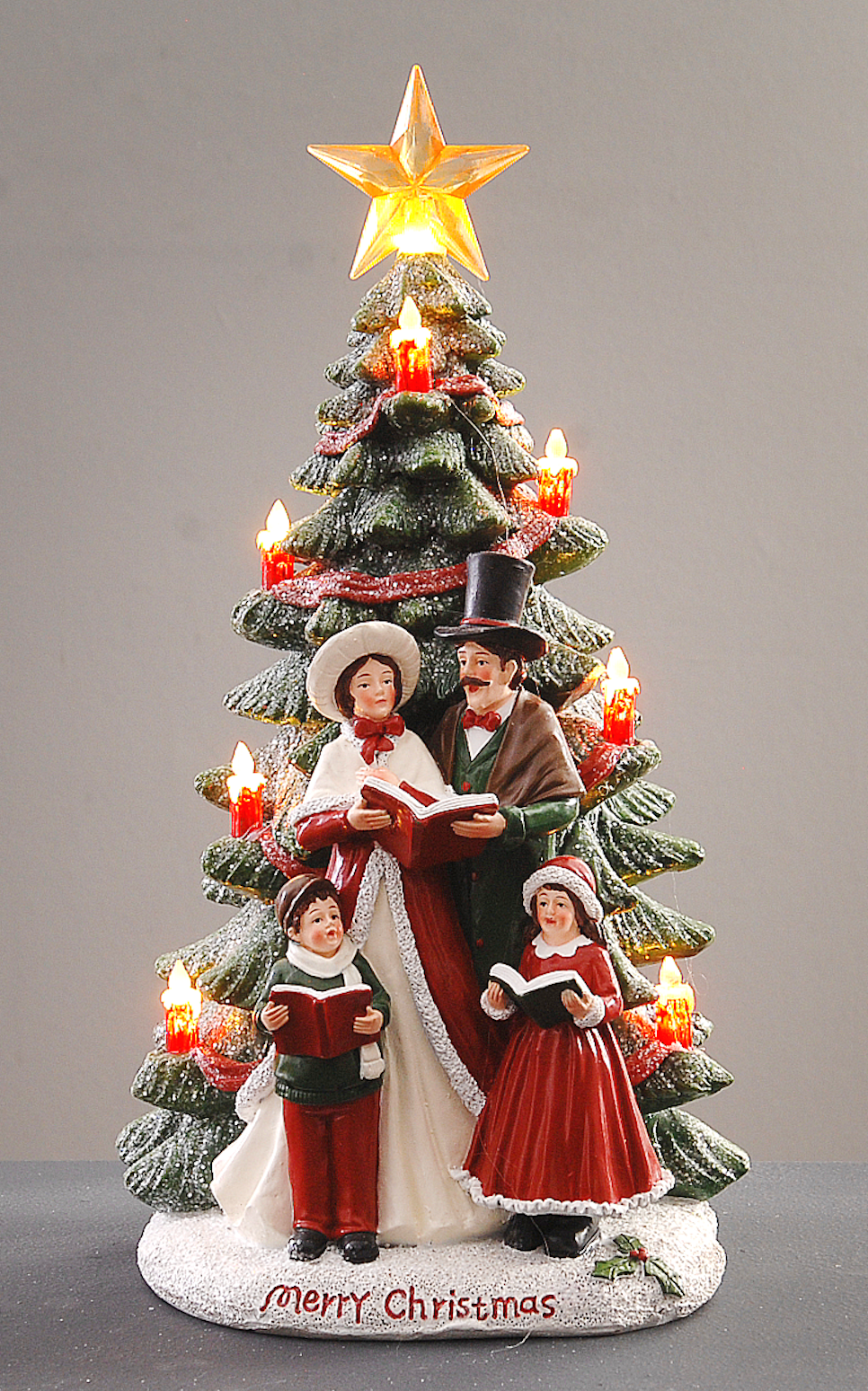 Juletre med gulstjerne og kor foran - julepynt